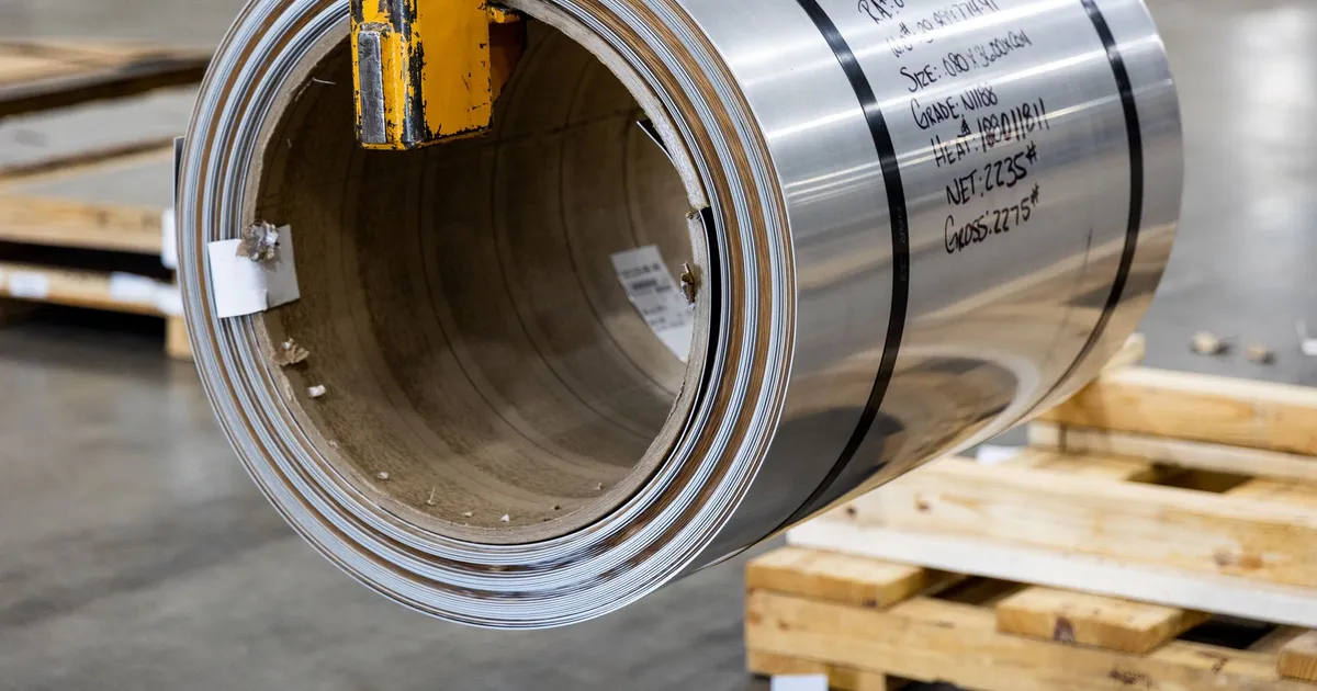 Coil of thin rolled metal strip, illustrating thin sheet stock of the kind handled in tungsten plate machining