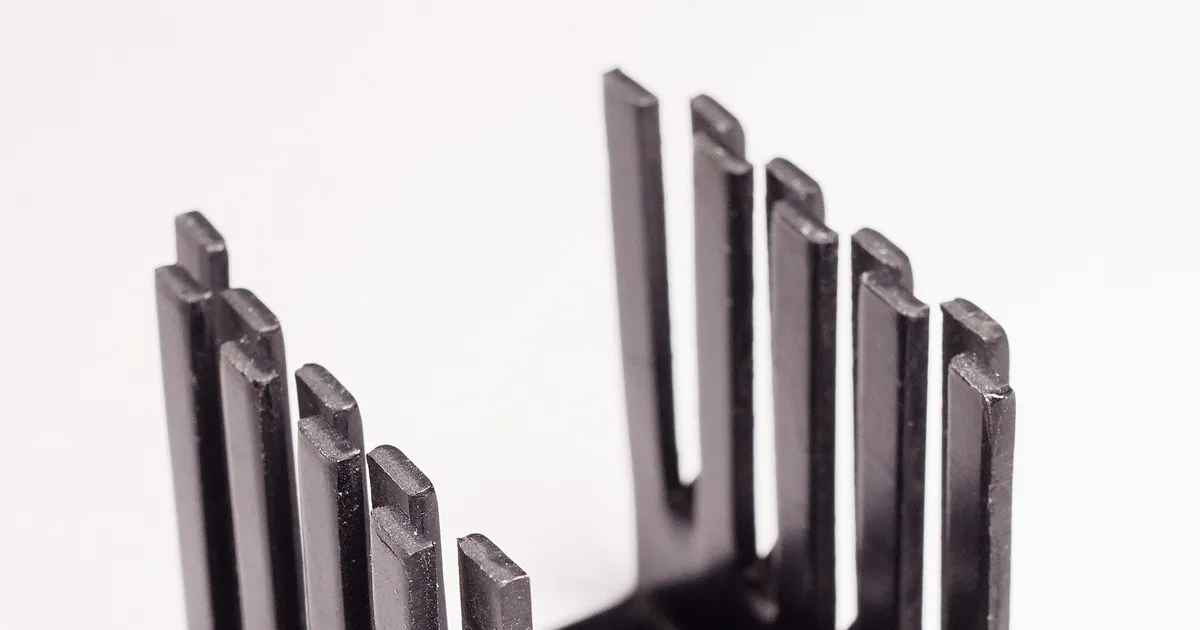 Small black heat sink for a power transistor, illustrating heat removal in the molybdenum copper vs tungsten copper choice